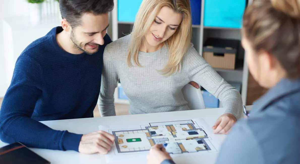 Personer studerer plantegninger med konsulent